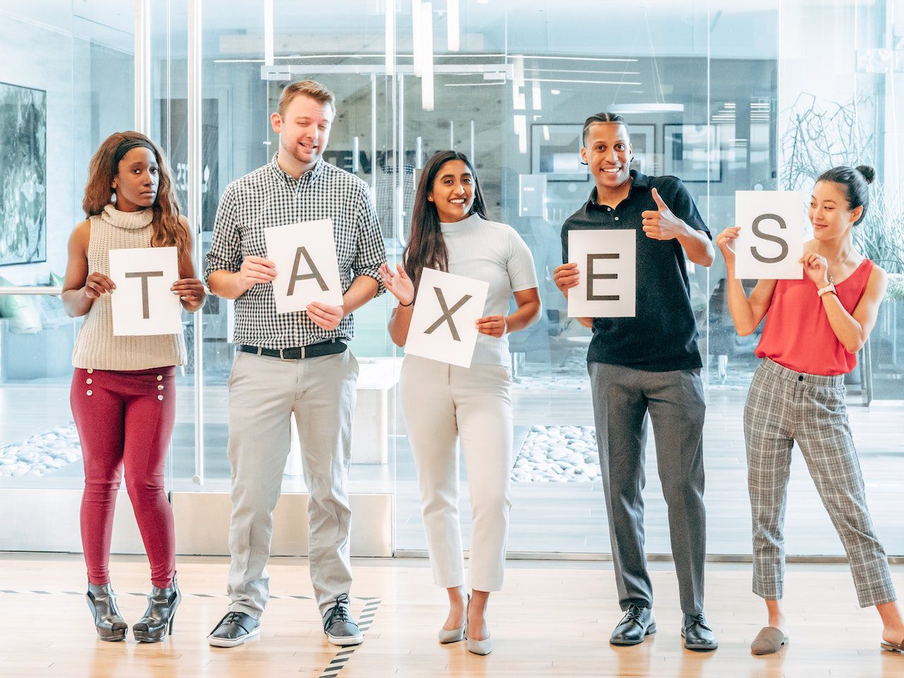 a group of people holding up signs that say taxes