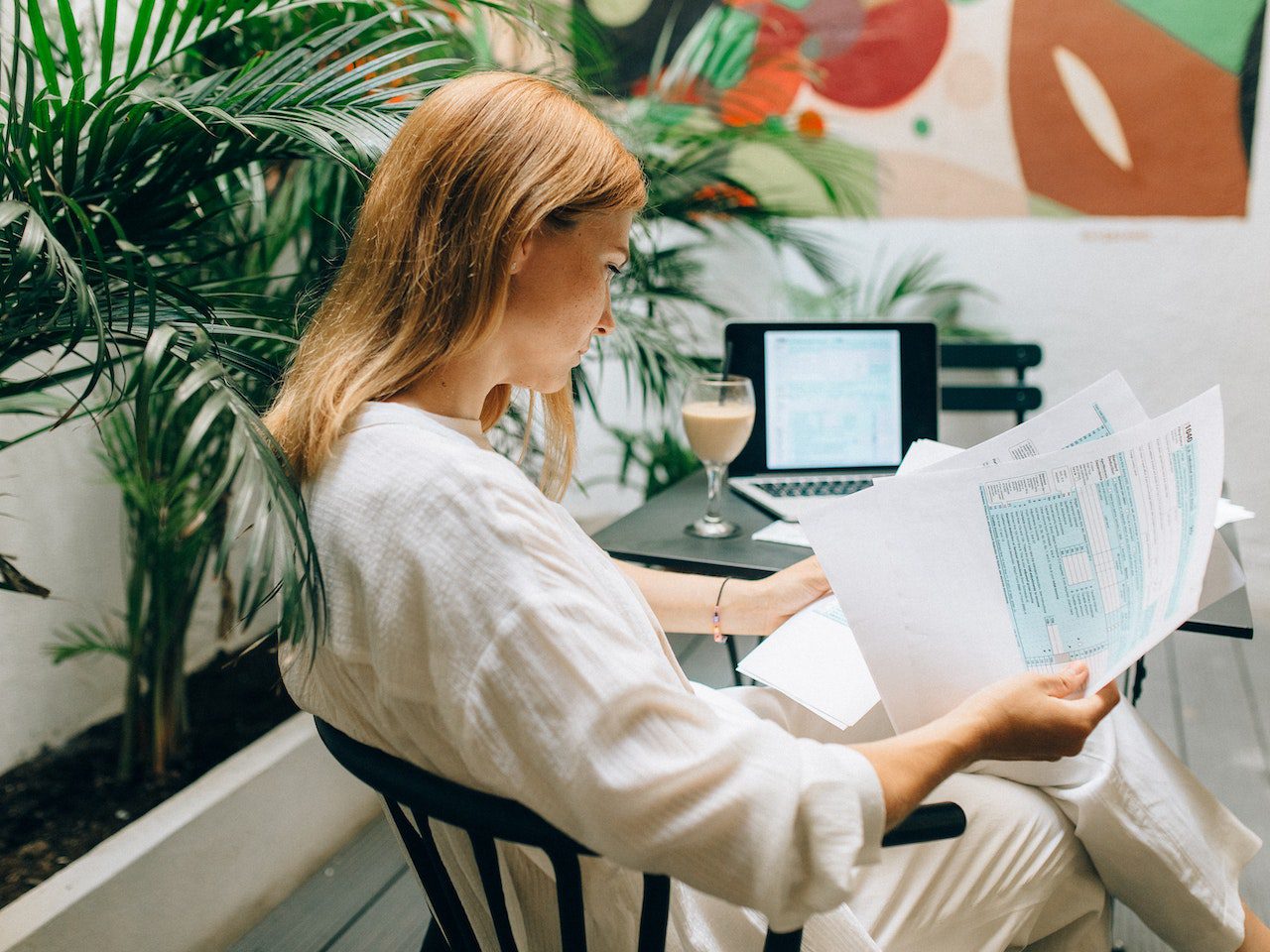 A Woman Reviewing Documents while Sitting