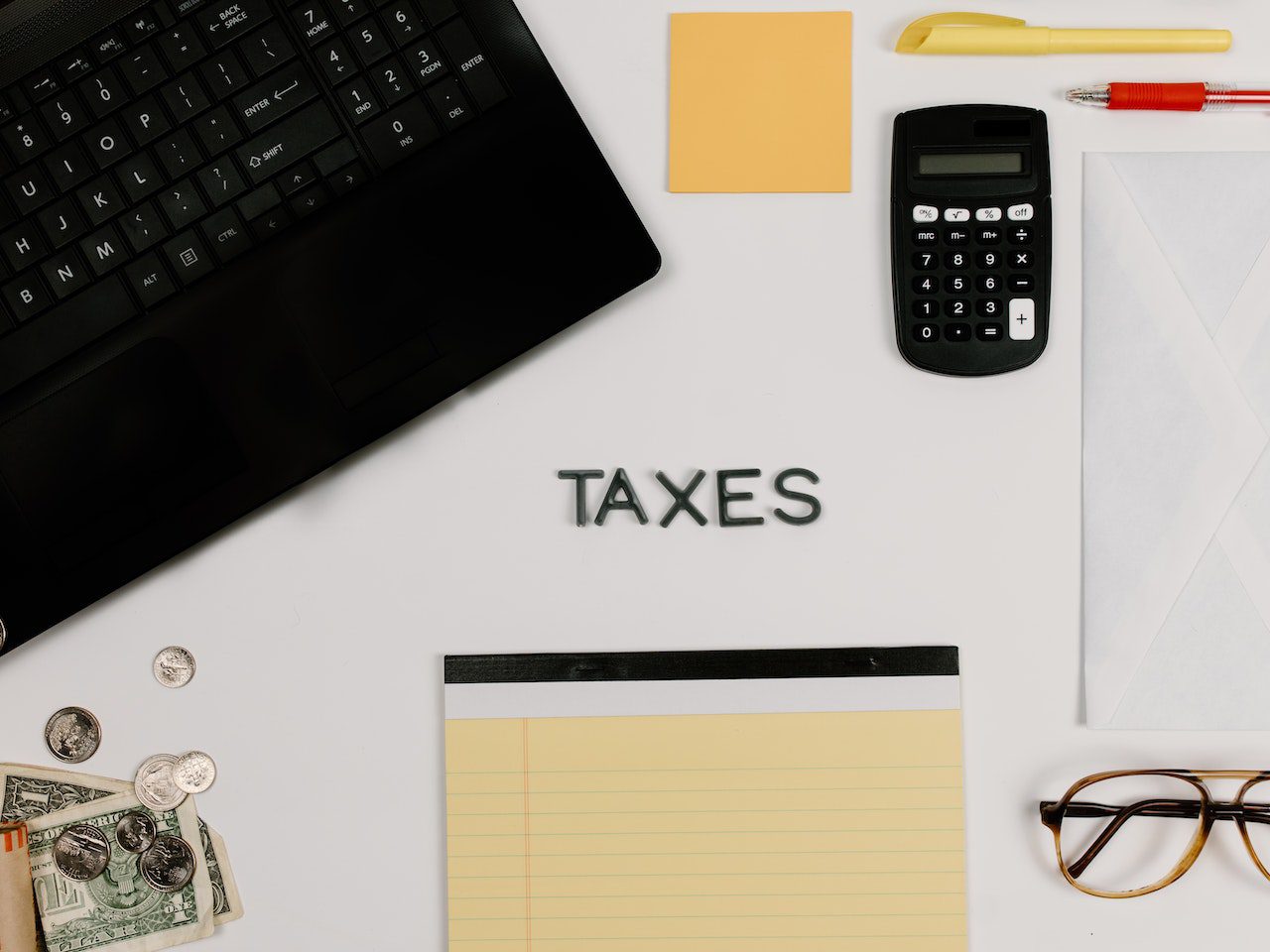 A Black Calculator beside a Laptop<br />
